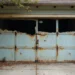 broken garage door illustrating costly risks of ignored repairs