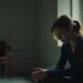 grieving woman sitting alone reflecting on deep personal loss