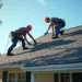 roofing crew installing new shingles on residential roof