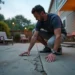 homeowner inspecting concrete before redesigning an outdoor nashville patio
